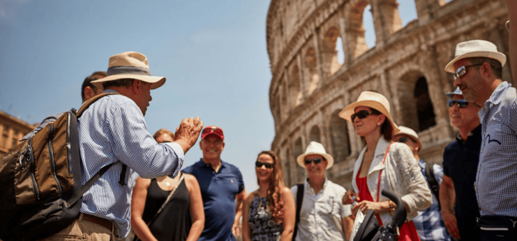 Tour guide with a group outside Colosseum
