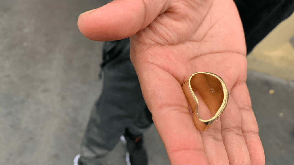 Golden ring handed to a person