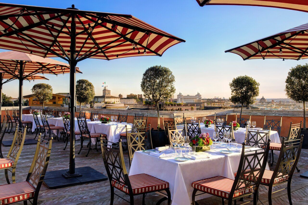 Cielo Rooftop bar in Rome during the sunset with the white linnen on the tables.