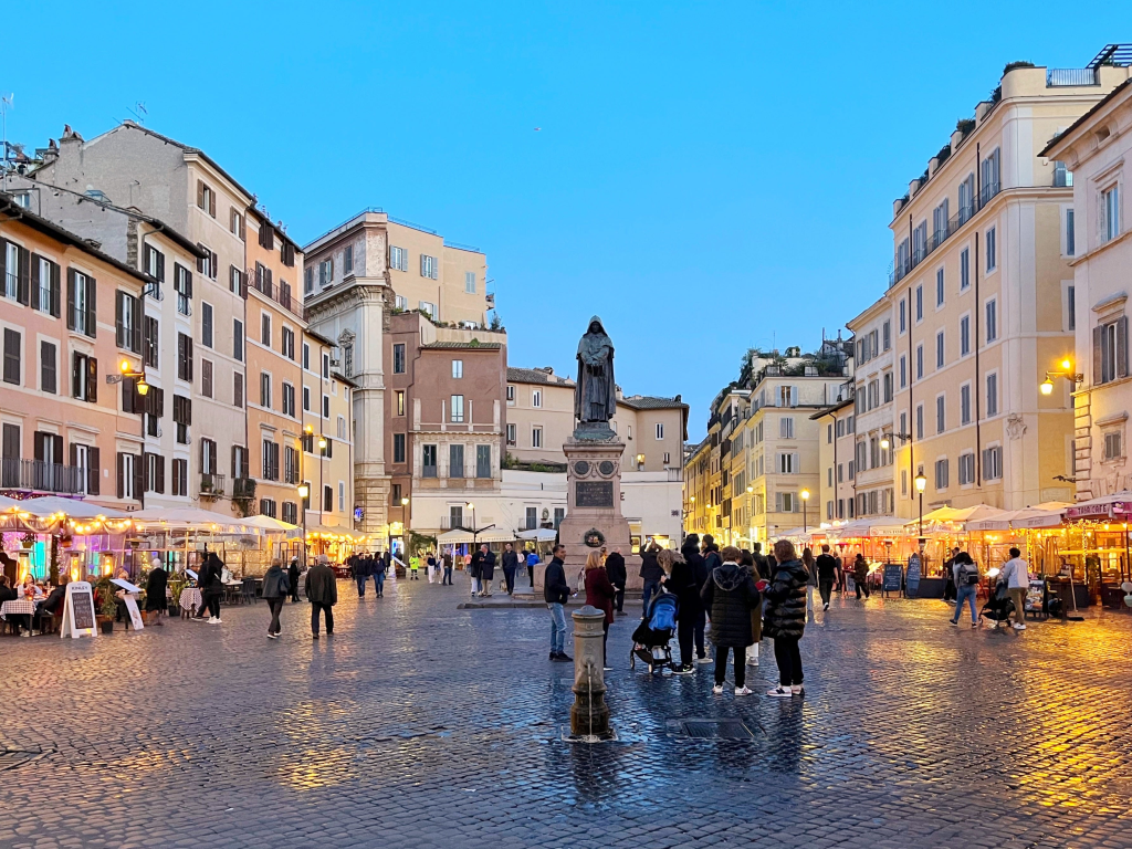 Campo de' Fiori main square in the rain during the evening.
